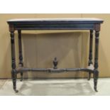 A late Victorian aesthetic movement period ebonised fold over top card table of rectangular form,