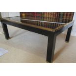 A contemporary occasional table of rectangular form, raised on ebonised frame work with brass banded