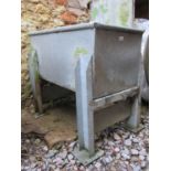 A galvanised trough/planter of rectangular form with rounded edge, raised on removable supports. 125