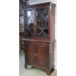 A Georgian mahogany side cabinet in two sections, the upper enclosed by a pair of astragal glazed