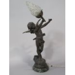 A French cast spelter figural table light of cupid holding a flaming torch, upon a stepped