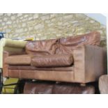 A "Halo" three seat stitched tan leather three seat club sofa with loose cushions and turned bun