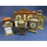 A mixed collection of clocks to include four carriage clocks, a reproduction lantern type clock