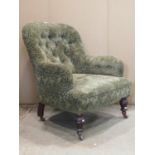 A Victorian spoonback drawing room chair with green ground repeating floral patterned upholstery and