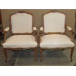 A pair of fauteuil with cream ground lattice patterned upholstered seats and shield shaped backs