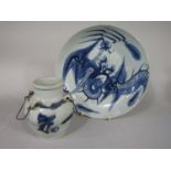 A 19th century oriental dish with painted blue and white decoration to the interior and exterior