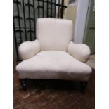A substantial Victorian library or drawing room chair, reupholstered in calico, raised on turned