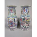 A pair of 19th century oriental vases with painted famille rose decoration incorporating panels with