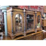 A Victorian figured walnut veneered side cabinet enclosed by three panelled doors, the central