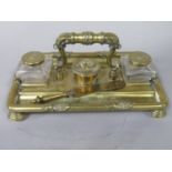 19th century cast brass standish, with scrolled acanthus handle, inset with two glass ink wells,