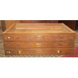 A vintage oak framed three drawer plan chest half section, (lacks top) 115 cm wide x 40 cm high (AF)
