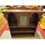 An Arts & Crafts style narrow oak freestanding open bookcase with fixed shelves surrounding a