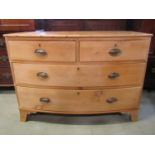 A 19th century stripped pine bow front low bedroom chest of two short over two long graduated