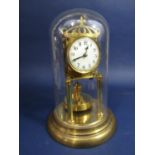 A brass German torsion clock, with disc weighted pendulum, under a glass dome, 28cm high in total