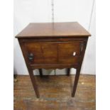 A simple Georgian mahogany pot cupboard, enclosed by a single door on square cut supports with brass