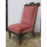 A late Regency/William IV rosewood nursing chair with pink dralon upholstered horse hair seat and
