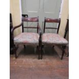 Two Regency mahogany open elbow chairs with decorated splats, together with three further regency