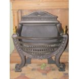 A Georgian style cast iron fire grate with bow fronted basket, brass urn finials, trailing