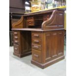 A good quality early 20th century oak kneehole twin pedestal roll top desk, the S shaped tambour