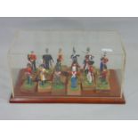 Presentation case displaying 18 individual standing figures of historical soldier figures in