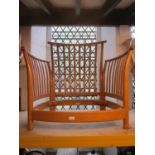 An Ercol Renaissance light elm armchair with open slatted and turned framework