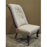A Victorian mahogany nursing chair, with cream ground oak leaf and acorn pattern upholstered seat