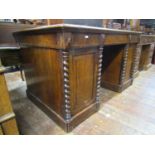 A Victorian oak pedestal desk fitted with three frieze drawers, the pedestals each with fielded