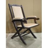 An Edwardian folding chair with simply upholstered pad seat, back and arm rests within a moulded