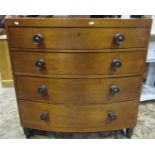 A 19th century bow front caddy top bedroom chest of four long graduated drawers raised on turned