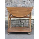 An Ercol medium elm and beechwood three tier drop leaf tea trolley together with a contemporary