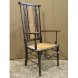 An Edwardian stained beechwood high back, open light weight elbow chair, with cane panelled seat and