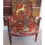 A mahogany framed elbow chair in the Empire style, the show wood frame with applied gilded mounts,