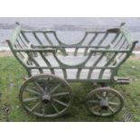 A small old vintage agricultural type hand/dog cart with shaped splats, spoke wheels, iron rims