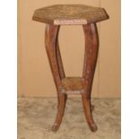 A Japanese soft wood two tier occasional table of octagonal form with carved dragon and further