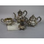 Victorian four piece lobed baluster tea service, engraved with scrolled foliage with flower mounts