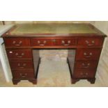A reproduction Georgian style mahogany veneered kneehole twin pedestal desk, with inset green
