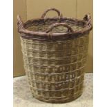 A large wicker four handled log basket of circular tapered form approximately 70 cm high