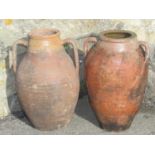 Two similar old terracotta oviform jars/amphora with moulded open loop handles and ribbed detail, 46