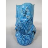 An oriental turquoise glazed vase with high relief moulded decoration of entwined carp, 24cm tall