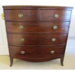 An early 19th century mahogany bow fronted chest of three long and two short drawers, on swept