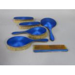 1920s six piece and guilloche enamel dressing set comprising four brushes comb and hand held mirror,
