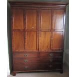 An unusual Georgian mahogany robe/hanging cupboard with moulded and dentil cornice over a pair of