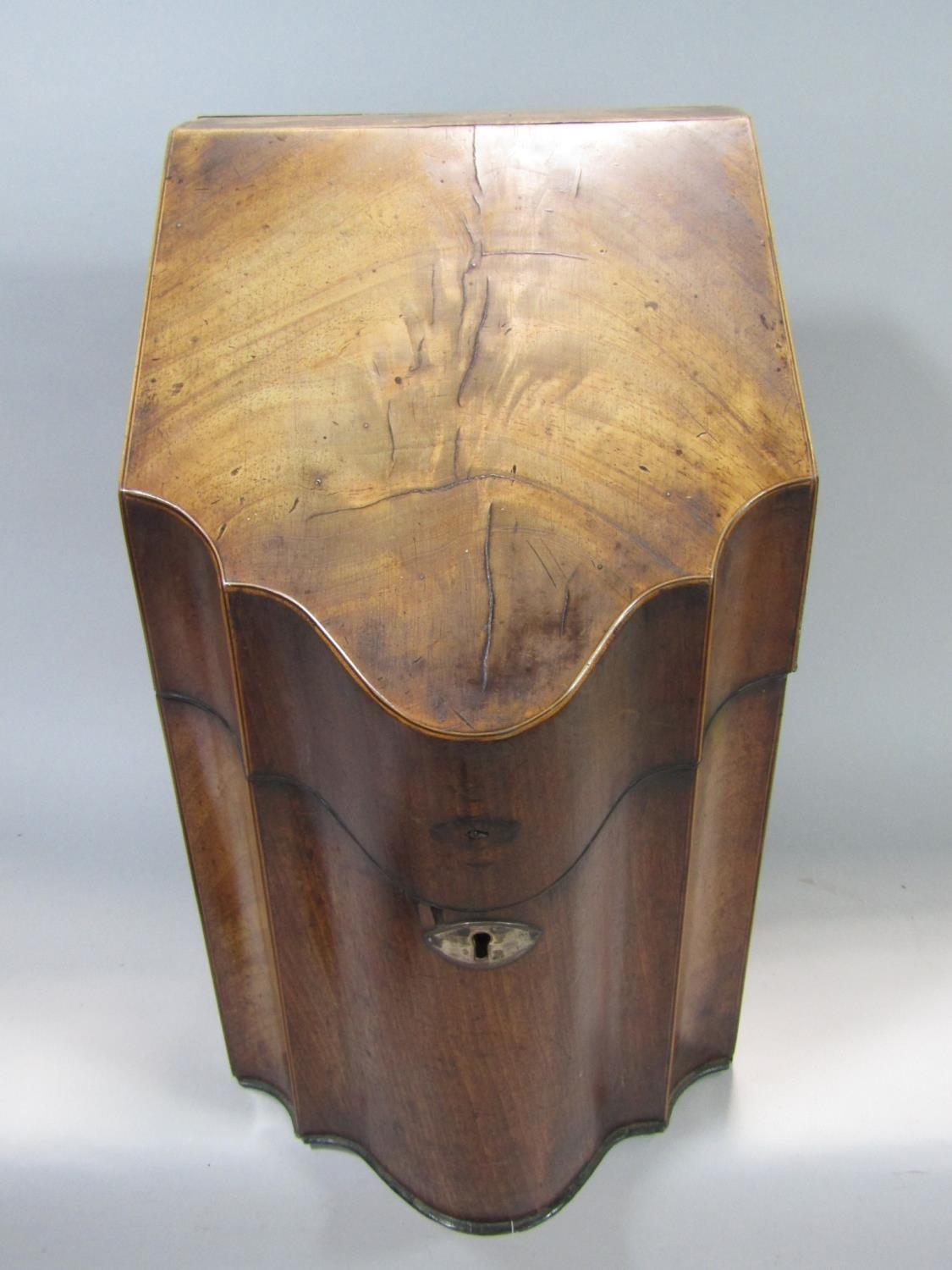 19th century mahogany serpentine knife box, the hinged lid enclosing a segmented interior, fitted