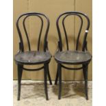 A set of four Bentwood cafe chairs with hoop backs, circular seats and ebonised finish