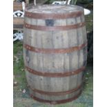 A coopered oak and steel banded bourbon whisky barrel, 88 cm high