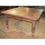 A large Victorian mahogany extending dining table, raised on four octagonal and turned supports,