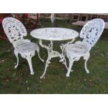 A cast aluminium garden terrace table of circular form with decorative pierced foliate detail,