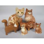A Winstanley model of a seated ginger cat, with painted signature to base, 22cm tall approx,