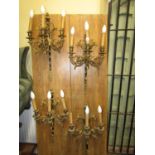 A set of four high quality, three branch wall lights in steel and gilded brass, with flamboyant