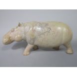 A carved soapstone figure of a standing hippopotamus, 34cm long